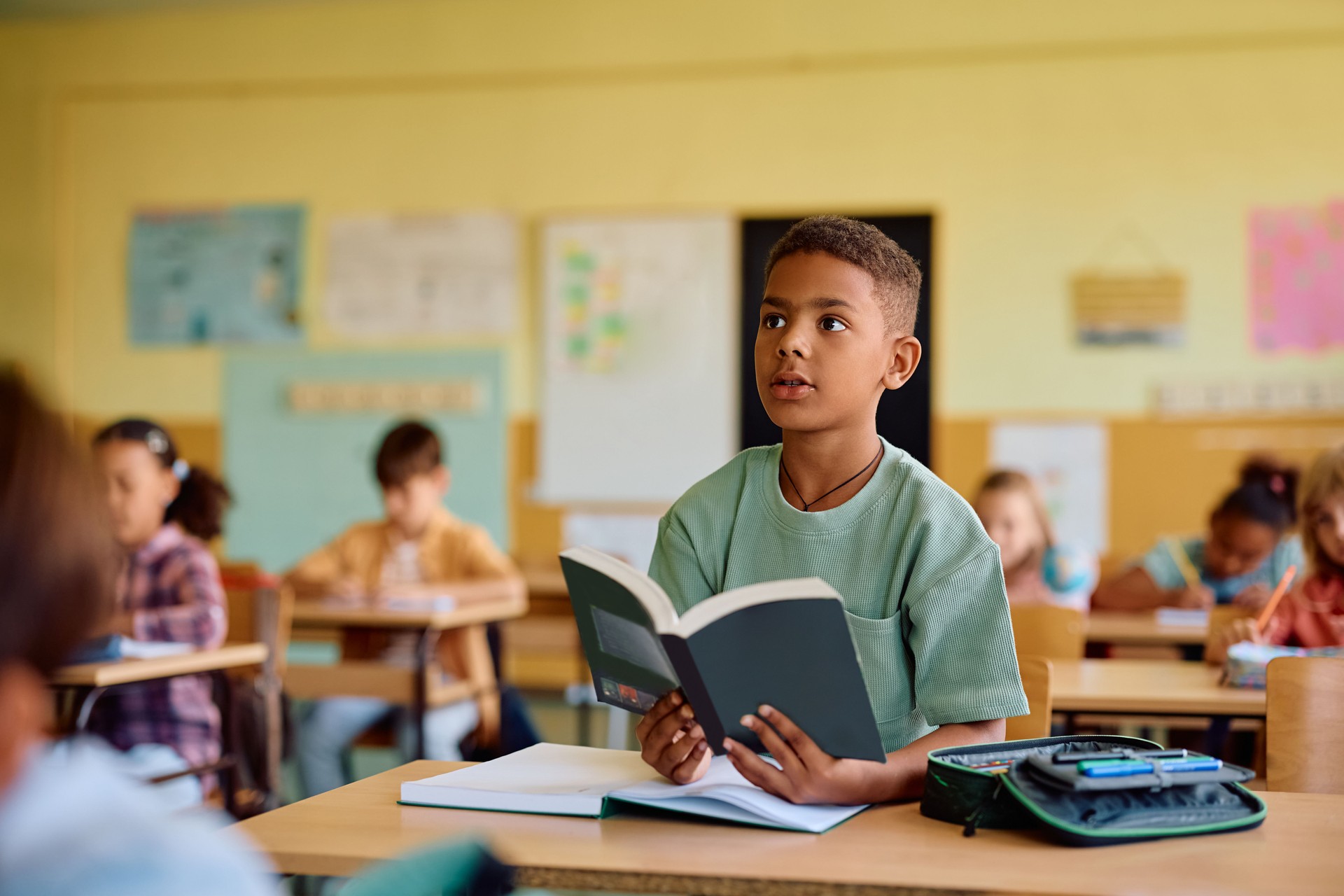 Black student learning during a class at elementary school.